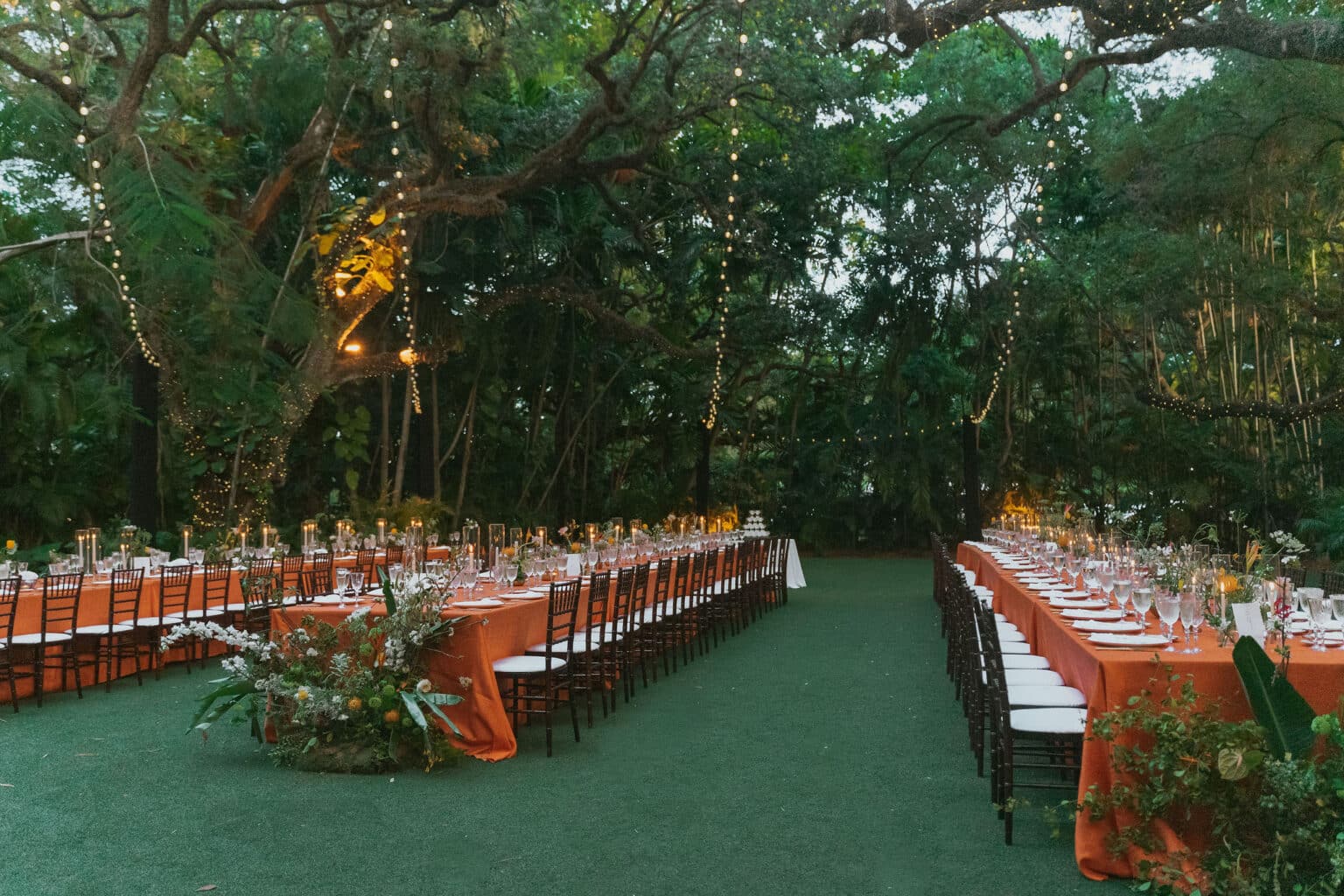 two long tables with unique floral installs at the ends