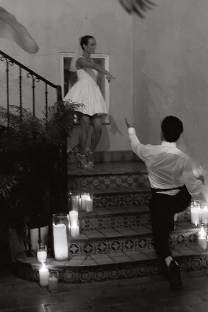 modern couple with short bride dress coming down stairs