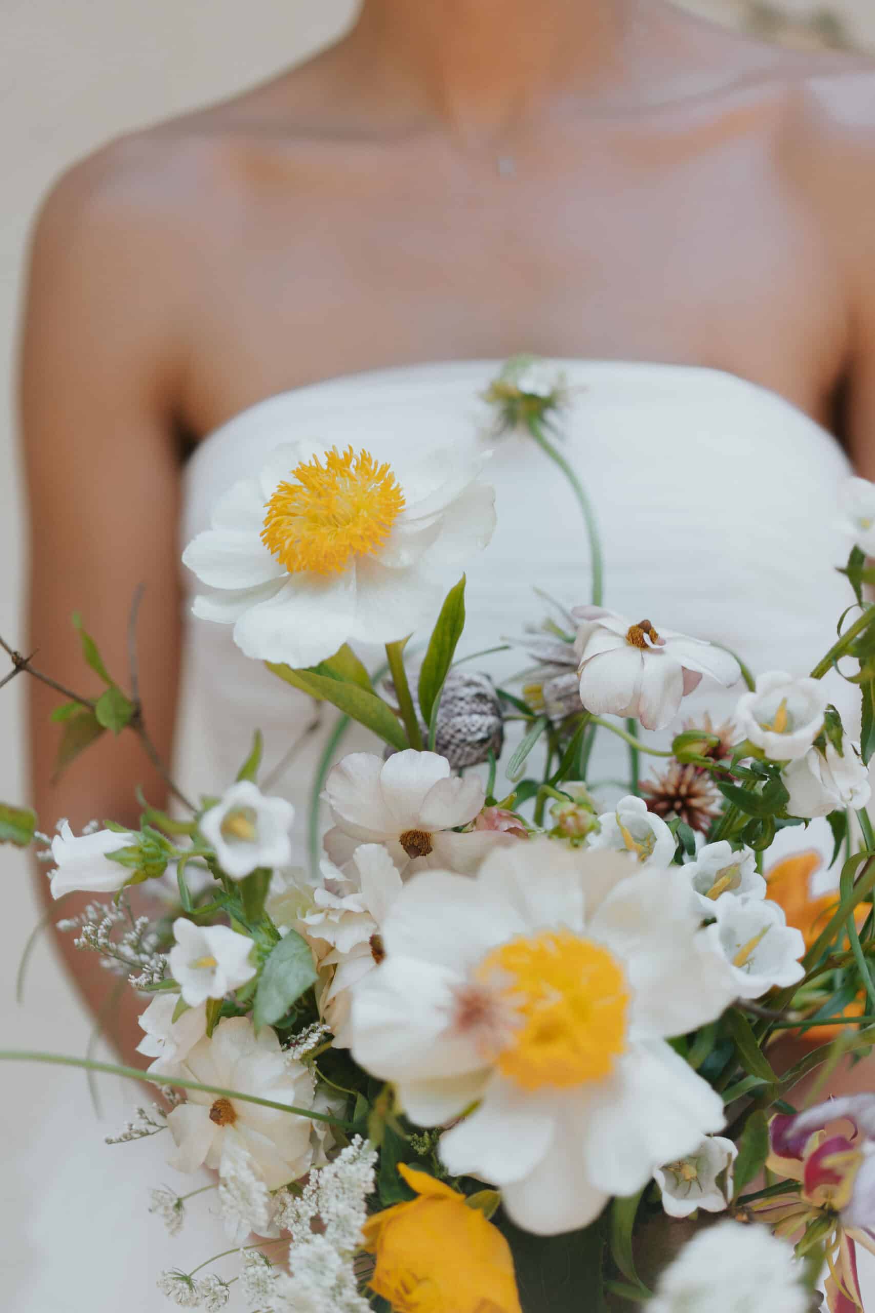 bride holding a whimsical bouquet with claire de lune peonies