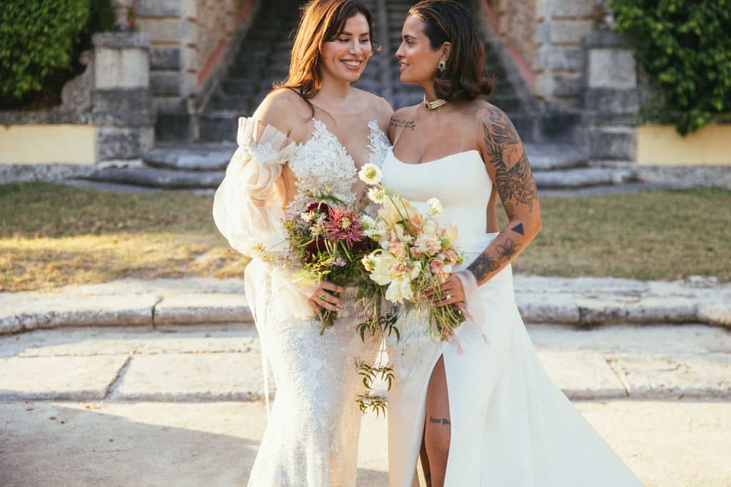 lesbian couple with complementary bridal boquets in vizcaya