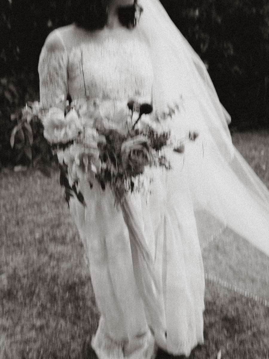 shot of a bride with her bouquet by simple florals and her vail