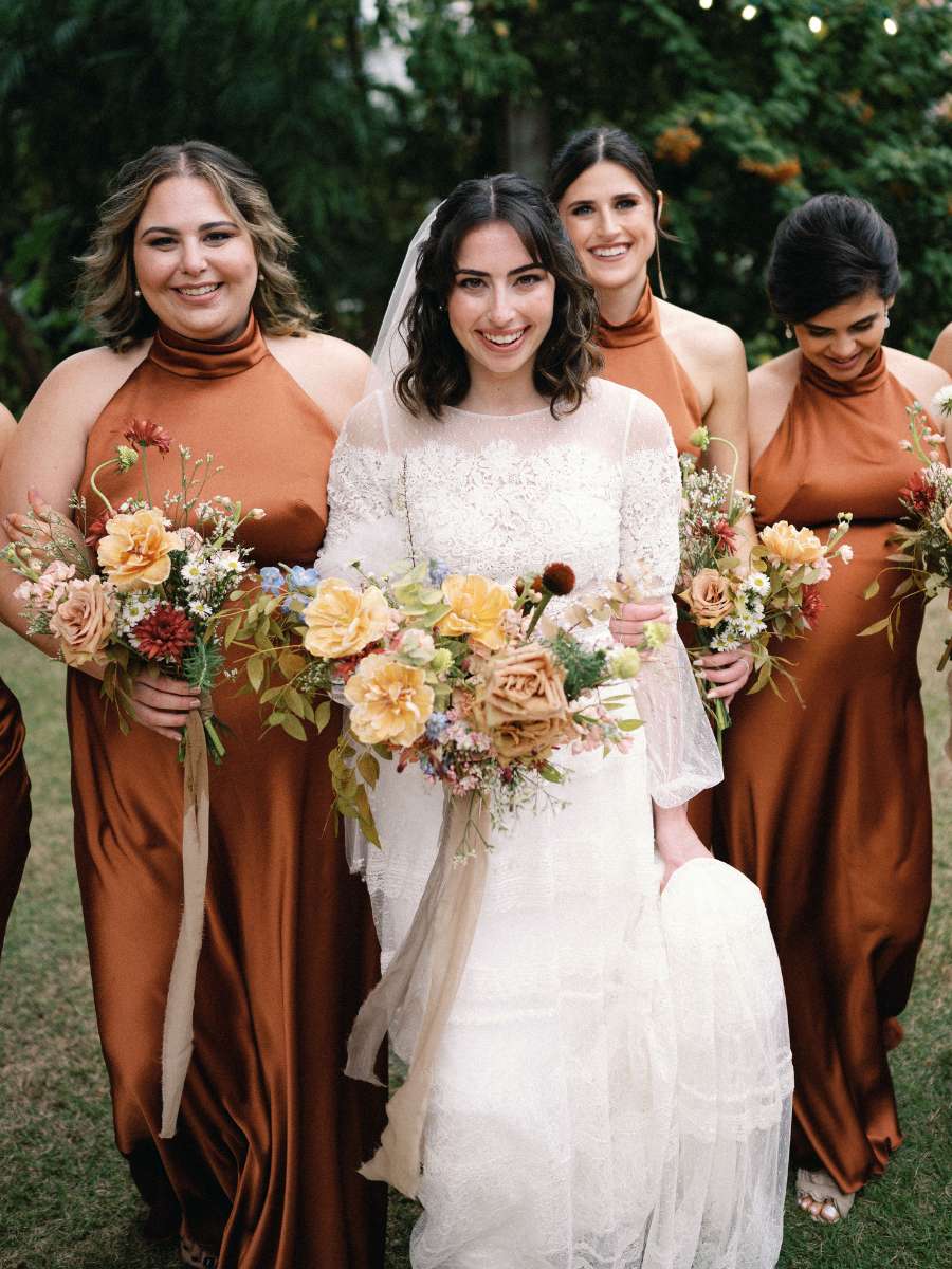 bridesmaids with bride, showcasing their garden wedding bouquets at a wedding in miami, fl
