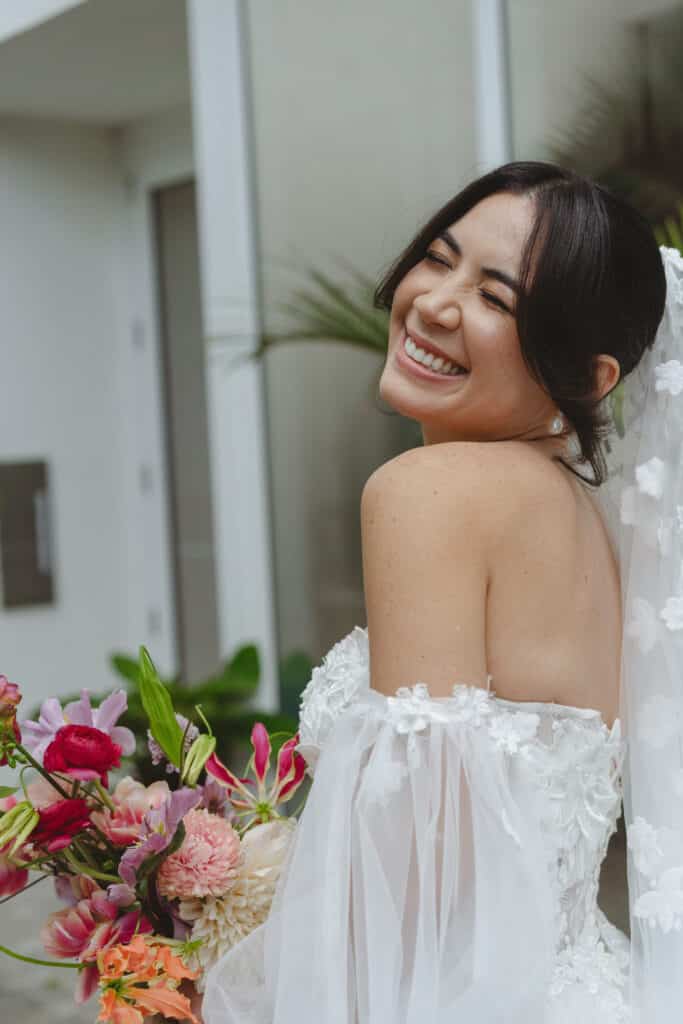 bride with tropical flowers smiling