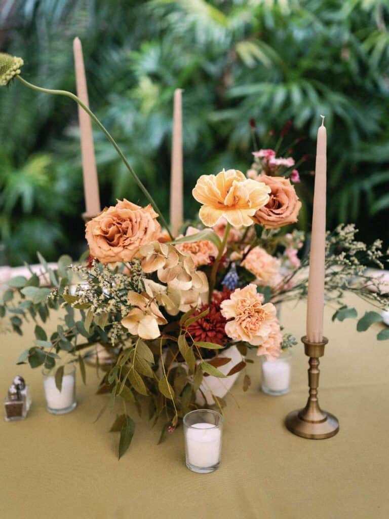 garden wedding table setting with sand-colored taper candles and toffee roses in miami beach botanical