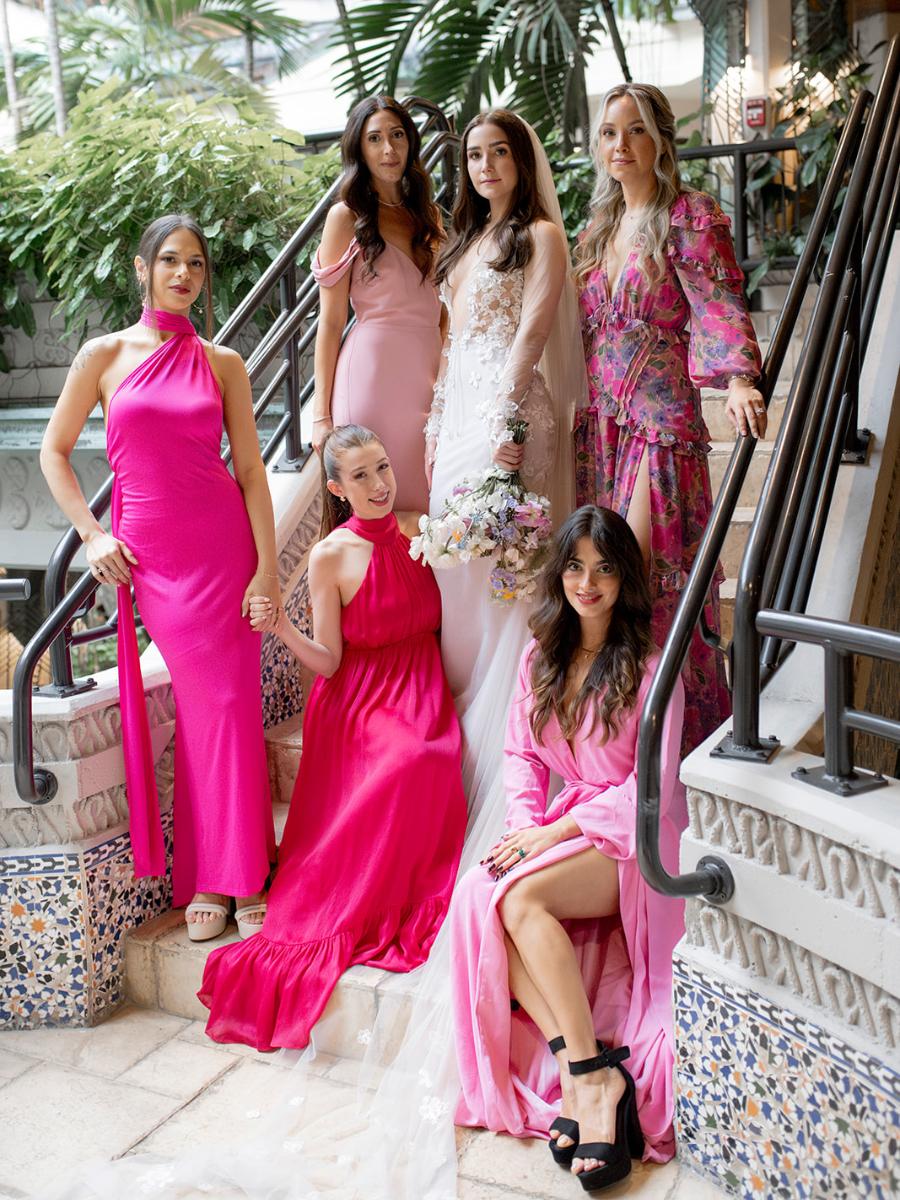 bride with bridesmaids in vibrant pink dresses at whimsical garden wedding in Coconut Grove