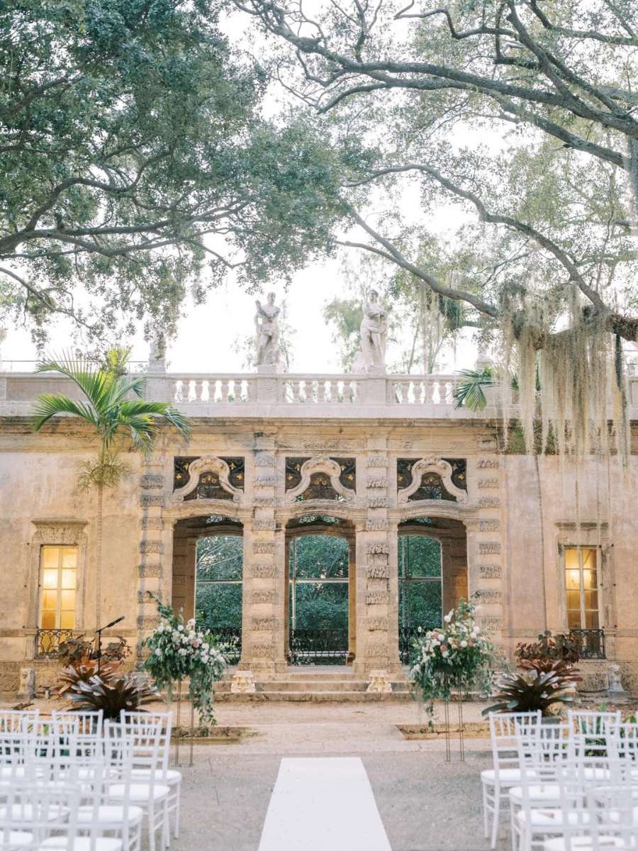 historical venue with outdoor wedding ceremony setup in front of classic architecture at vizcaya