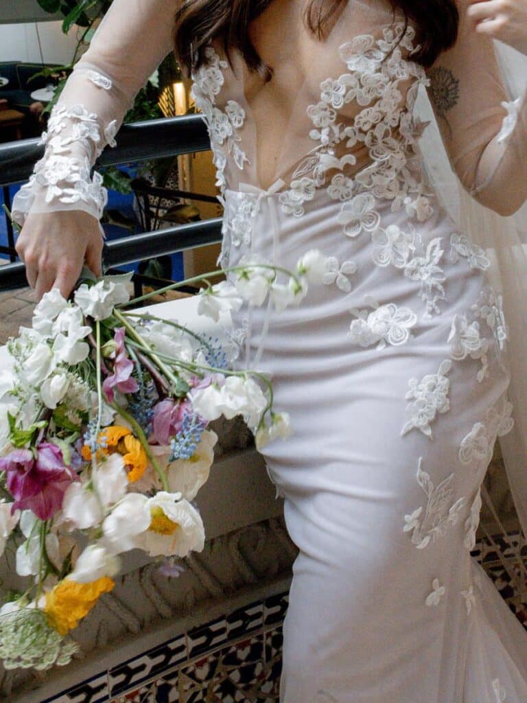 bride holding a whimsical garden-style bouquet featuring wildflowers at a fairytale wedding